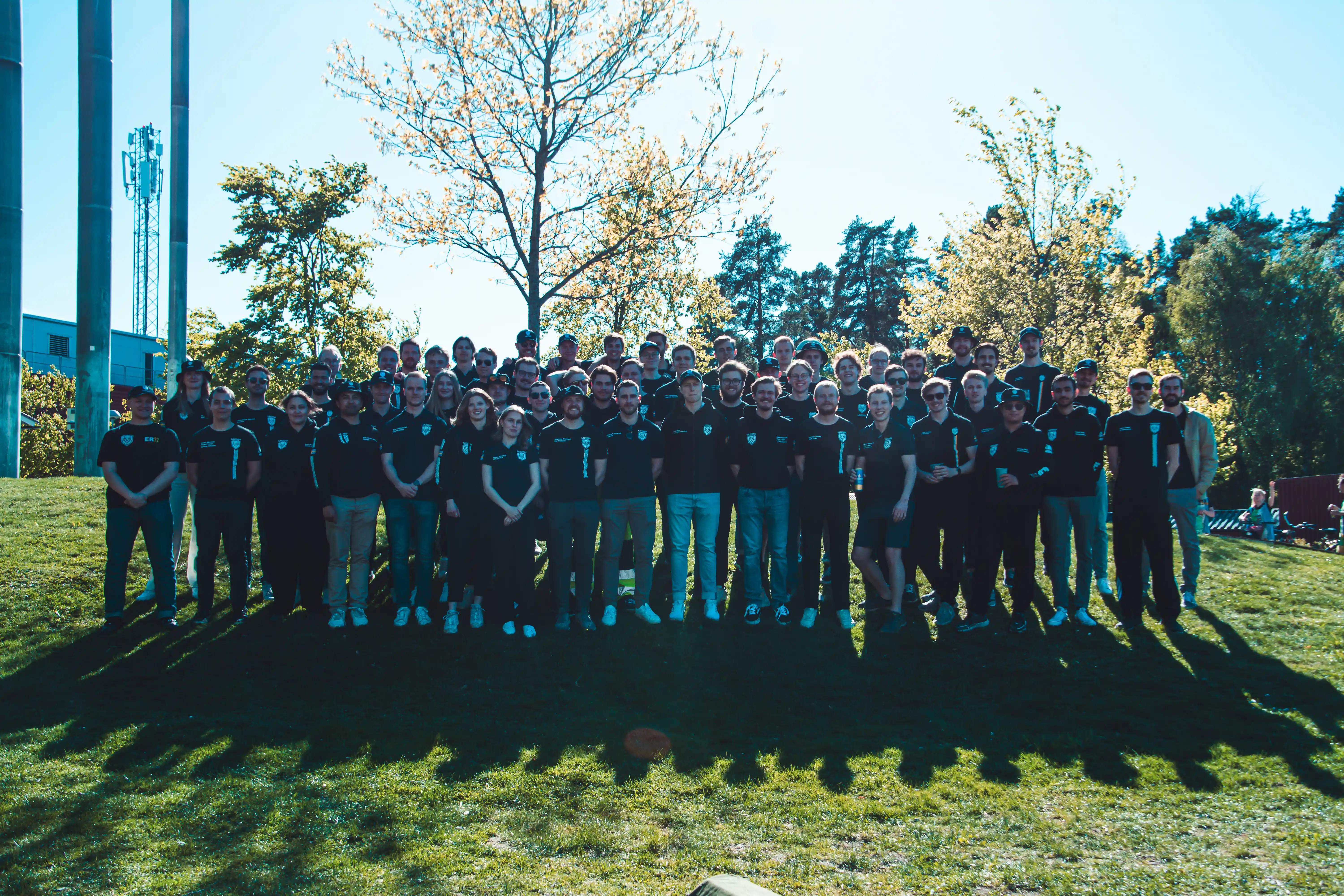 Team members working together around the car